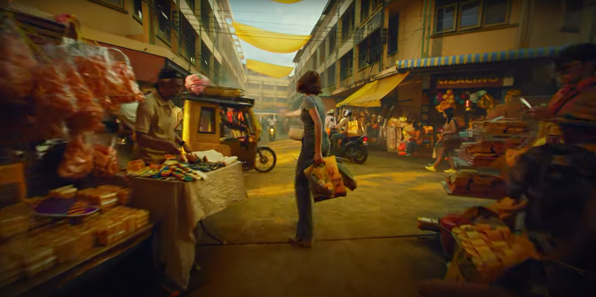 Delta Sync video poster image of woman in open-air market